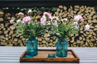 Kaboompics - Pink flowers on a wooden table in a sunny garden