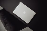 Kaboompics - MacBook laptop on black table