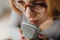 Woman Recording ASMR Sounds On Microphone