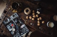 Kaboompics - New Yorker, some nuts, watches, and other things on the old, wooden table