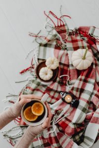 Kaboompics - Orange tea - blanket - white pumpkins - candle - flatlay