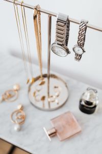 Jewellery Stand on a Marble Table, White Background, pink perfumes