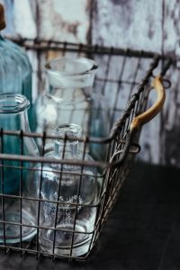 Kaboompics - Collection of bottles in metal mesh basket