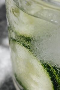 Kaboompics - Water glass - cucumber - ice cubes - marble - closeup - close-up - close up