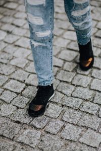 Kaboompics - Woman in black sneakers and blue jeans