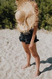 Kaboompics - Beautiful woman with sunglasses and a summer straw hat