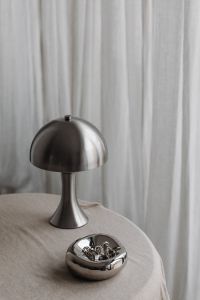 Kaboompics - Metal desk lamp Zara Home - Silver Jewelry - Linen Tablecloth - Books