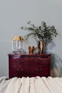 Kaboompics - Cabinet with gold decorations and eucalyptus