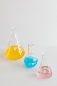 Kaboompics - Flat-bottomed and conical flask wiith blue yellow pink liquid