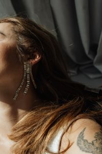 Kaboompics - Woman is wearing beautiful zirconia earrings