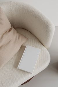 Kaboompics - Free photos for mockups - blank cover book - cream armchair - linen pillow