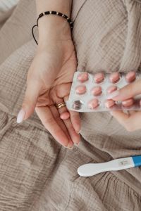 Pregnant Woman Taking Vitamin Pills - positive pregnancy test