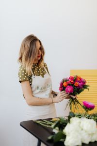 A beautiful woman florist makes a bouquet