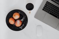 Kaboompics - Marble desk with laptop, homemade Polish doughnuts and coffee