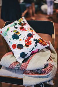 Pillow with colourful dots on a chair