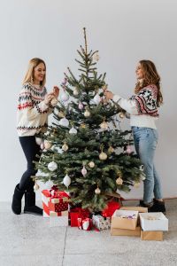Kaboompics - Women Decorate Christmas Trees