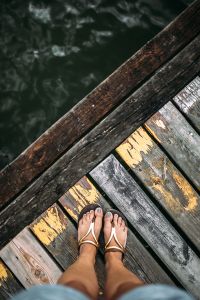 Kaboompics - Detail of the legs of a woman standing at the edge of the pier