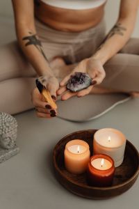 Young adult woman - candles - palo Santo - crystal