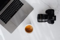 Kaboompics - Coffee, laptop and camera on a white marble table