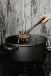 Hand of a woman preparing pasta