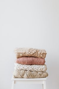 Kaboompics - Colourful sweaters on the wooden stool