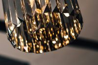 Kaboompics - Elegant black designer chandelier with a lit lightbulb