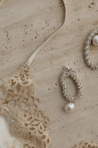Kaboompics - Satin light beige bra trimmed with lace - silver earrings with zircons and pearls