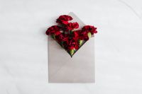 Kaboompics - Red carnations in an envelope