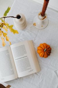 Kaboompics - Opened book - pumpkin - vase - candle