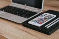 Kaboompics - Silver Acer laptop, a white Apple iPhone and a black notebook on a wooden desk