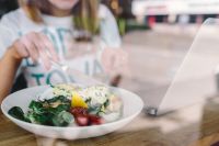 Kaboompics - Close up image of young woman eating classic breakfast at restaurant