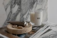 Kaboompics - Luxurious Scented Candles on Marble Surface with Lifestyle Magazine - UGC Style Home Decor Photography