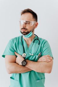 Young male doctor in mask