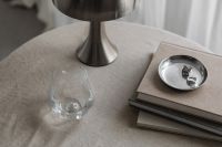 Kaboompics - Metal desk lamp - Silver Jewelry - Glass Of Water - Linen Tablecloth