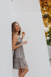 Kaboompics - Blond Woman in a Sequin Dress is Holding a Glass of Champagne