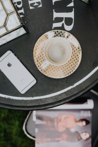 Kaboompics - Top view of table with coffee, mobile hone and magazine
