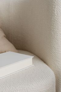 Kaboompics - Free photos for mockups - blank cover book - cream armchair - linen pillow