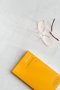Kaboompics - Book and glasses on white marble