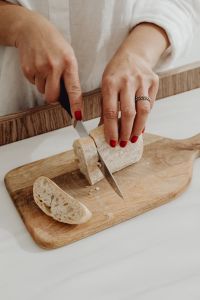 Kaboompics - Slicing bread - ciabatta - bakery