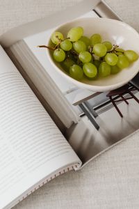 Kaboompics - Magazine and grapes in a bowl on a linen couch