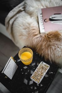 Bedside table, iPhone mobile, Kinfolk magazine and cup of orange juice