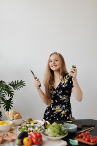 Kaboompics - Teen Girl holding a knife and cucumber