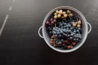 A colander with grapes