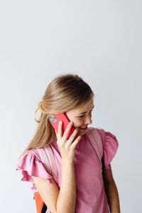 Young girl uses phone