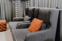 Kaboompics - Cozy grey armchairs with orange pillow in living room