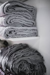Grey woolen fabric stacked on shelves