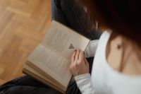 Beautiful young woman reading a book