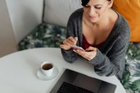 Kaboompics - A brunette woman works with a laptop and a phone