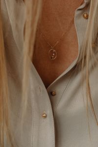 Kaboompics - Details of gold jewelry - beautiful woman wearing a tan silk shirt