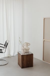Kaboompics - Wooden side table with marble top - bright ceramic vases - concrete floor - microcement